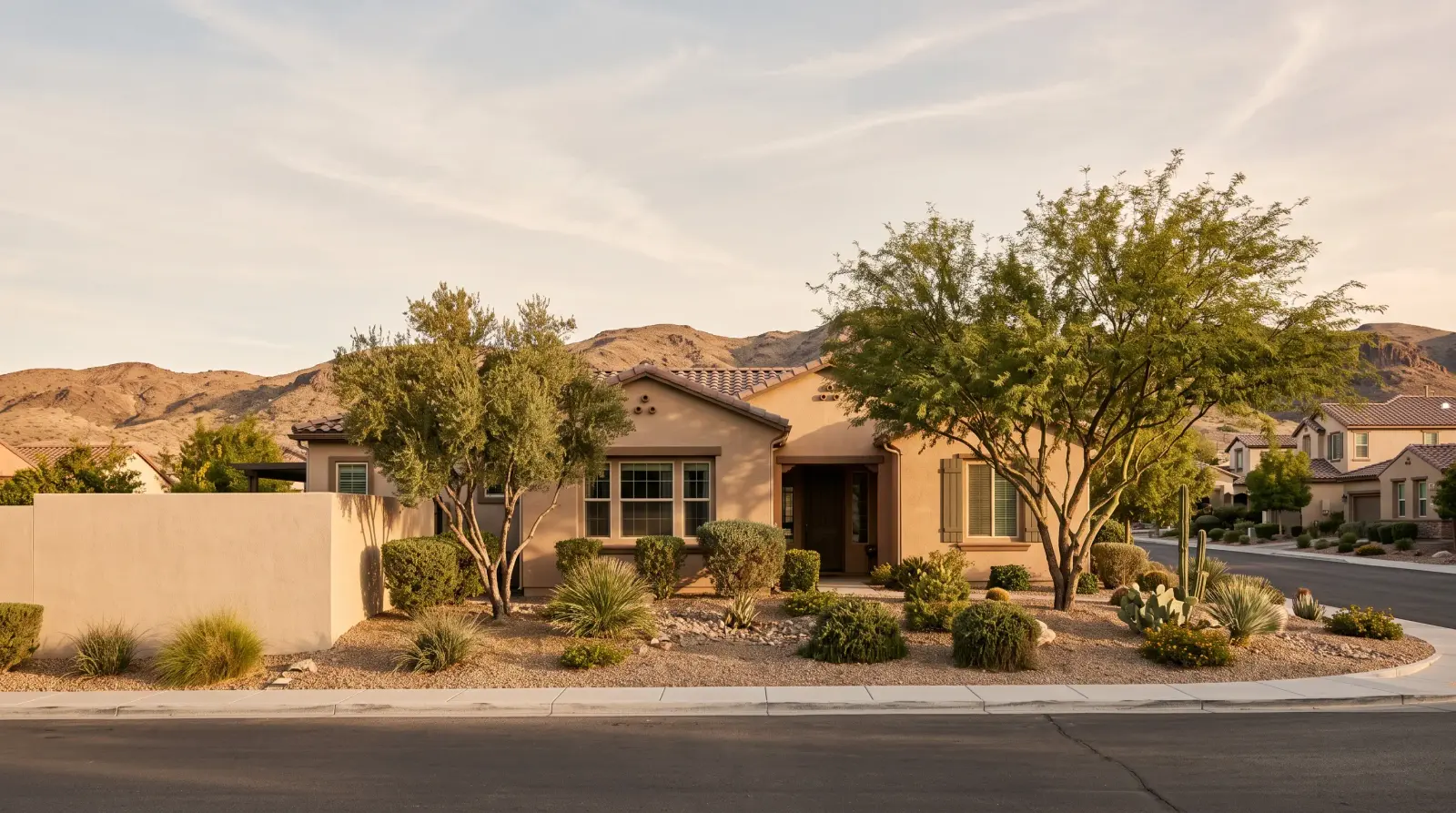 Single-story stucco home with desert landscaping and hills behind it in Boulder City, Nevada