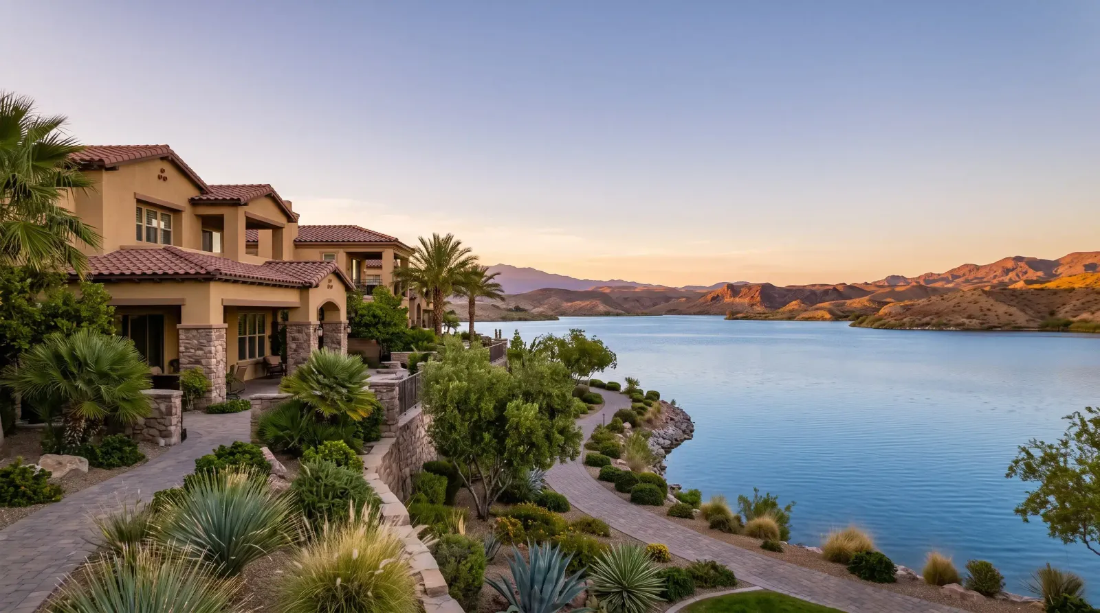 Homes with palm trees and desert plants beside a lake in Lake Las Vegas, Nevada