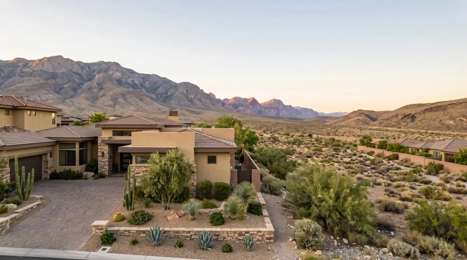 Desert home with stone landscaping and mountains in the distance in Summerlin, Nevada
